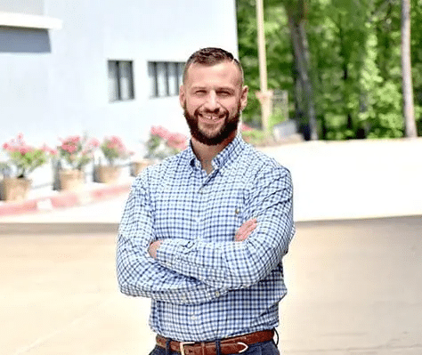 Professional headshot of Zachary Geiling, APRN, a Healthy Connections team member wearing a blue plaid dress shirt.