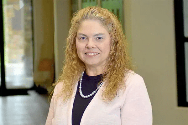 Professional headshot of Carolin Hockersmith, APRN, a Healthy Connections team member wearing a pink cardigan.