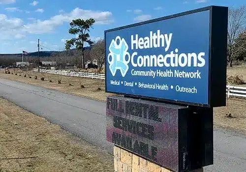 The sign for the Healthy Connections Mena Community Pharmacy.